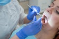 Woman dentist checking her patient for caries. Red-haired woman examined by a doctor. The girl will do the health of the Royalty Free Stock Photo