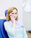 Woman at the dentist complains of toothache. Looki