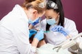 Woman dentist doctor makes teeth check up for patient men Royalty Free Stock Photo