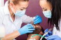 Woman dentist doctor makes teeth check up for patient men Royalty Free Stock Photo