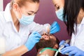 Woman dentist doctor makes teeth check up for patient men Royalty Free Stock Photo