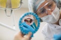 Woman dentist doing teeth checkup of man in a dental chair. Royalty Free Stock Photo