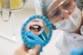 Woman dentist doing teeth checkup man patient in a dental chair at medical clinic Royalty Free Stock Photo