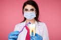 Woman dentist with gloves showing on a jaw model how to clean the teeth with tooth brush properly and Royalty Free Stock Photo