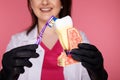 Woman dentist with gloves showing on a jaw model how to clean the teeth with tooth brush properly and Royalty Free Stock Photo