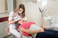 Woman dentist in her office treating female patient Royalty Free Stock Photo