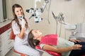 Woman dentist in her office treating female patient Royalty Free Stock Photo