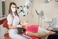 Woman dentist in her office treating female patient Royalty Free Stock Photo