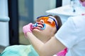 Woman dentist selects the shade for the teeth before teeth whitening Royalty Free Stock Photo