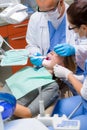 Woman at dentist surgery have teeth treatment