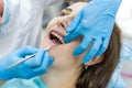 Woman in dentistry demonstrating teeth to doctor