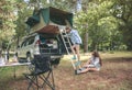 Woman descending ladder form tent over car Royalty Free Stock Photo