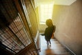 Woman descending stairs apartment house building