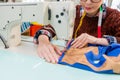 Woman designer hands holding designing clothing