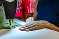 Woman designer working creating garment on sewing machine Royalty Free Stock Photo