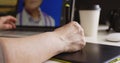 Woman designer working at a laptop with a graphics tablet.