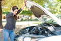Woman In Despair Looking At Broken Car Royalty Free Stock Photo