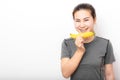 Woman with detal braces holding banana