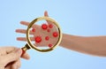 Woman detecting bacteria with magnifying glass on background, closeup. Prevention disease