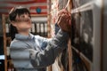 Woman detective searching terrorist act connections, looking on evidence board. Royalty Free Stock Photo