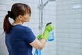 Woman with detergent spray washcloth cleaning bathroom Royalty Free Stock Photo