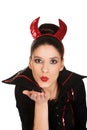Woman in devil costume blowing a kiss. Royalty Free Stock Photo