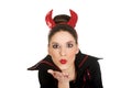 Woman in devil costume blowing a kiss. Royalty Free Stock Photo