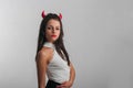 Woman with devil horns and red lips posing on black background Royalty Free Stock Photo