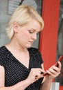 Blond Woman Dialing Cell Phone Royalty Free Stock Photo