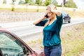 Woman dialing her phone after car crash Royalty Free Stock Photo