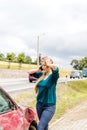 Woman dialing her phone after car crash Royalty Free Stock Photo