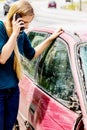 Woman dialing her phone after car crash Royalty Free Stock Photo