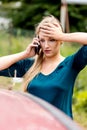 Woman dialing her phone after car crash Royalty Free Stock Photo