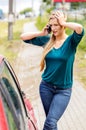 Woman dialing her phone after car crash Royalty Free Stock Photo