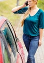 Woman dialing her phone after car crash Royalty Free Stock Photo