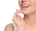 Woman with diastema between upper front teeth on white background, closeup