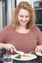 Woman On Diet Eating Healthy Meal In Kitchen Royalty Free Stock Photo