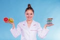 Woman with diet weight loss pills and grapefruits. Royalty Free Stock Photo