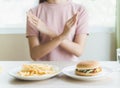 Woman on dieting for good health concept. Woman doing cross arms sign to refuse junk food or fast food