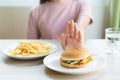 Woman on dieting for good health concept. Woman doing cross arms sign to refuse junk food or fast food. Royalty Free Stock Photo