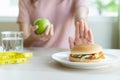 Woman on dieting for good health concept. Woman doing cross arms sign to refuse junk food or fast food.