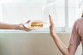 Woman on dieting for good health concept. Woman doing cross arms sign to refuse junk food or fast food hamburger and potato fried