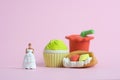 Woman dieting from junk food before wedding day concept. Miniature people toys photography, girl holding wedding dress. Image