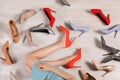 Woman and different stylish shoes on wooden floor Royalty Free Stock Photo