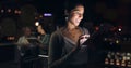 Woman, digital tablet and rooftop at night in city for social media, research and networking on urban background Royalty Free Stock Photo