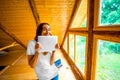Woman with digital tablet in wooden house Royalty Free Stock Photo