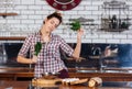 Woman with dill and parsley dacing on the kithen