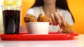 Woman dipping crispy fried chicken wings in ketchup sauce closeup, crunchy snack Royalty Free Stock Photo