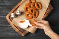 Woman dipping tasty onion ring into sauce