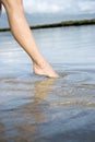 Woman dipping toe in water. Royalty Free Stock Photo
